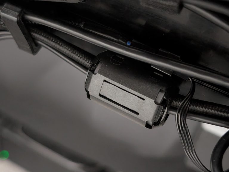 Close up picture showing a ferrite core clipped onto a wire